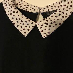 Black sweater with white/red hearts undershirt